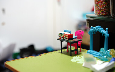 pile of books on desk toys on blur background