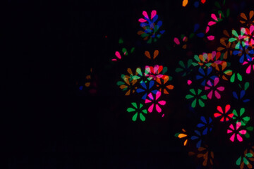 Bokeh lights background. Flowers bokeh defocused background. Holiday background. Garland. Defocused blinks. New Year. Bokeh retro style photo.