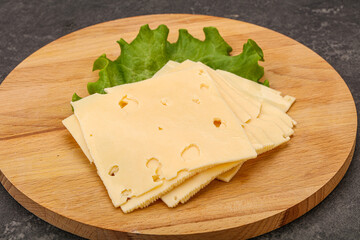 Sliced yellow cheese over board