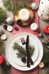 Concept of New year table setting with candles on gray table