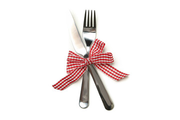 Cutlery with checkered bow isolated on white background