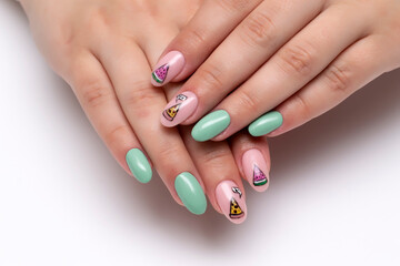 Summer manicure. Mint, beige manicure with drawn pizza, watermelon, on long oval nails close-up on a white background.