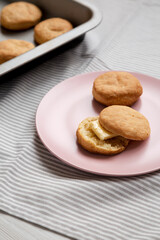 Homemade Flaky Buttermilk Biscuits on a pink plate, side view. Close-up.