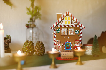 Christmas background with vintage house and decorative objects, candles and gifts