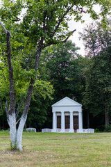 White gazebo in Roman style in the park