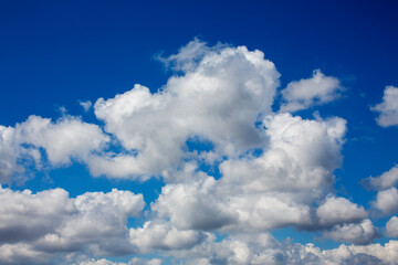 White clouds cumulus floating on blue sky for backgrounds concept