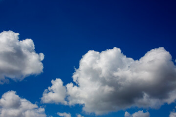 White clouds cumulus floating on blue sky for backgrounds concept