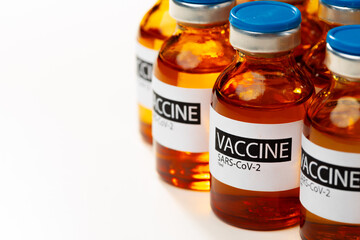 Sars-cov-2 vaccine vial bottles on white table