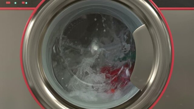 Close up view porthole of washing machine. Washing clothes process in slow motion.