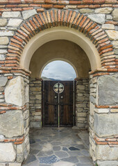 Brickwork, arch and wood door.