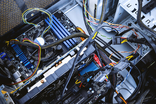 Dust on the cooler of a computer processor with a motherboard and a fragment of a computer case. Concept - Dust inside of a broken computer