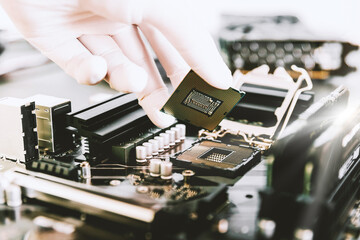 Fototapeta na wymiar Technician replace CPU microchip in the CPU socket on the motherboard