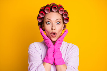 Close-up portrait of pretty lovely funky amazed housekeeper wearing curlers great news reaction isolated bright yellow color background