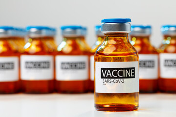 Sars-cov-2 vaccine vial bottles on white table