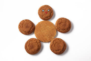Oatmeal cookies in the form of a smiling man on a white background.