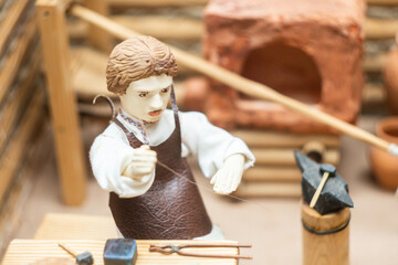 miniature figurines of people engaged in crafts