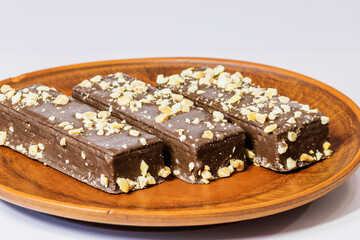 Chocolate wafers with nuts оn а clay plate