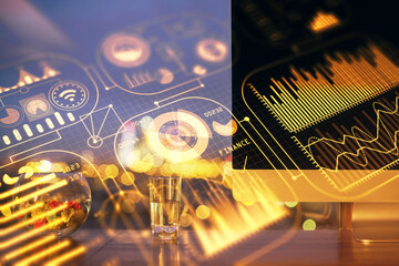 Computer on desktop in office with technology theme hologram. Double exposure. Tech concept.