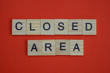 Obraz premium phrase closed area from gray wooden small letters with black font on an red table