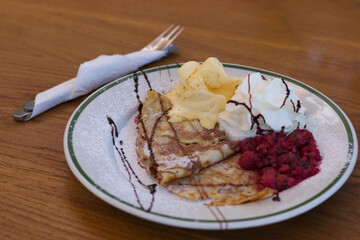 Pancake with raspberries and ice cream