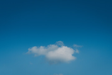 Minimal white cloud on deep blue sky background 
