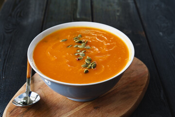 Homemade pumpkin soup on a black table
