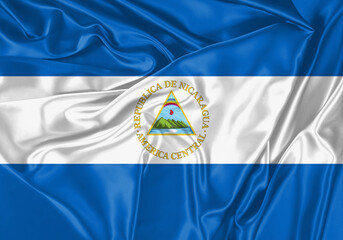 Nicaragua flag waving in the wind. National flag on satin cloth surface texture. Background for international concept.