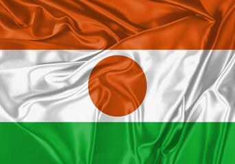 Niger flag waving in the wind. National flag on satin cloth surface texture. Background for international concept.