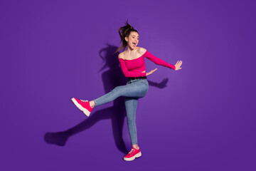 Full length body size view of pretty carefree cheerful girl dancing having fun isolated over bright violet color background