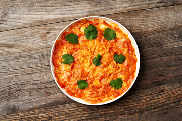 Fried eggs with tomatoes. Omelette on breakfast table