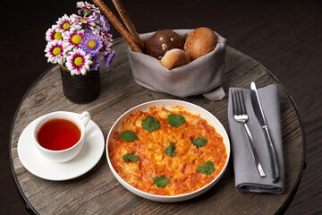 Fried eggs with tomatoes. Omelette on breakfast table