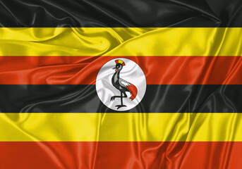 Uganda flag waving in the wind. National flag on satin cloth surface texture. Background for international concept.