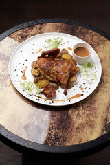 Grilled chicken Tabaka with baked potatoes and with sauce