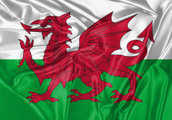 Wales flag waving in the wind. National flag on satin cloth surface texture. Background for international concept.