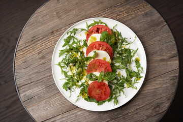 Italian caprese salad with sliced tomatoes, mozzarella