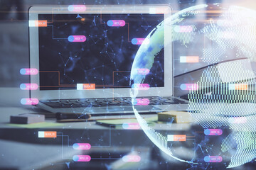 Double exposure of desktop with computer and world map hologram. International data network concept.