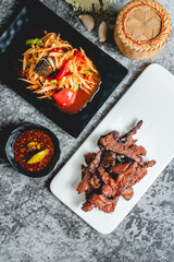 deep fried sun-dried pork (Moo dad deaw) with papaya salad(som tum), Thai food
