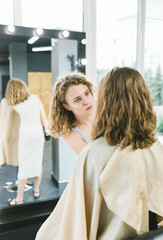 Obraz premium The eyebrow master works with the client. The girl performs the procedure of coloring her eyebrows. The concept of the salon and the eyebrows.