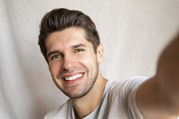 Portrait of a young attractive man doing a selfie with a gorgeous smile and perfect teeth  - Powered by Adobe