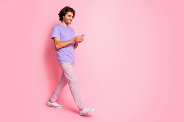 Fototapeta na wymiar Full size profile photo of handsome person walking write message wear magenta isolated on pink color background