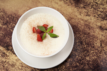 Oatmeal porridge with strawberry, raspberry and mint