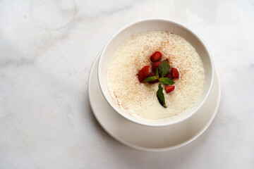 Oatmeal porridge with strawberry, raspberry and mint