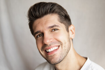 Portrait of a young handsome man with a beautiful smile and perfect teeth with a happy look 