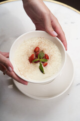 Woman with Oatmeal porridge with strawberry