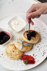 Pancakes with fresh berries and jam. Healthy breakfast table
