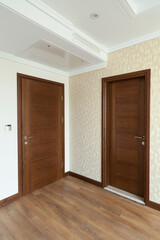 Two wooden interior doors next to each other