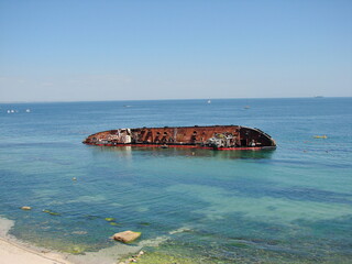 A sunken barge that hit the shores of the popular beaches of Odessa under the rays of the southern...