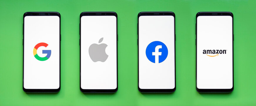 GAFA icons on smartphone screens with green background banner - Google, Apple, Facebook, Amazon