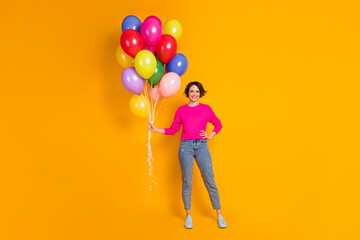 Fototapeta na wymiar Full body photo of nice girl hold many balloons wear pullover isolated over vivid color background