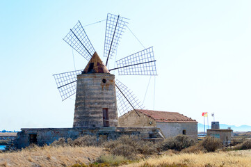 One of the many wind mill of the Trapani's salt pans with its characteristic red roof
